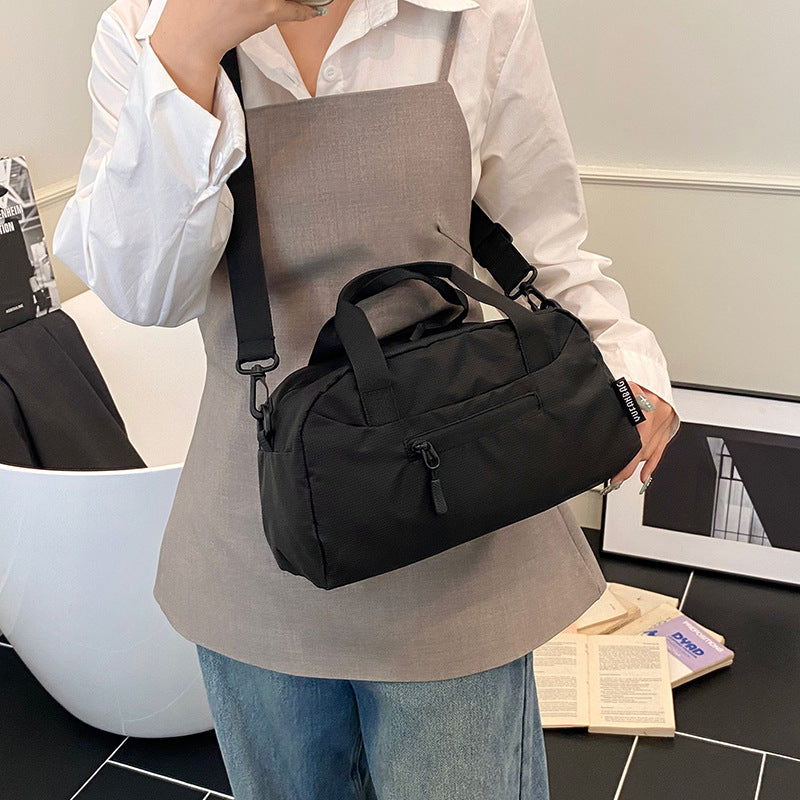 Cross-border women's lightweight handbags, large-capacity business travel bags, luggage bags, sports fitness bags, shoulder messenger bags.