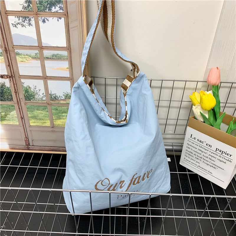 Casual large-capacity striped canvas bag women's 2025 new commuter shoulder bag lightweight versatile tote bucket bag