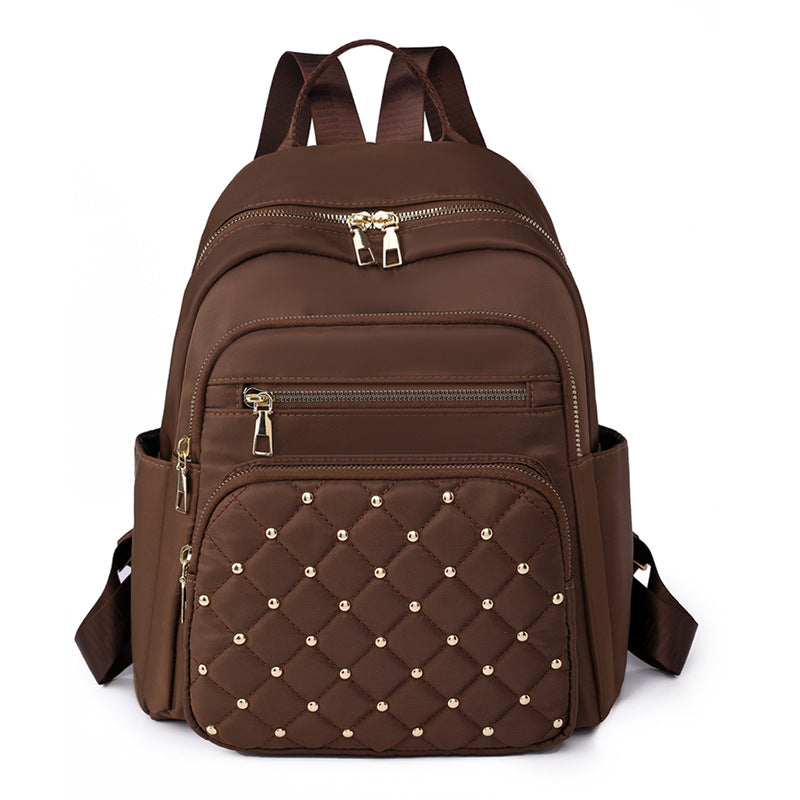 Solid color rhombus sewing line rivets fashion backpack women's 2025 texture Korean version large capacity simple women's backpack