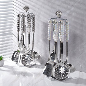 Wow, a seven-piece stainless steel cookware set with ceramic handles, boasting a subtle luxury aesthetic. features include a pearlized, high-end design and includes a soup ladle and spatula, perfect for home use