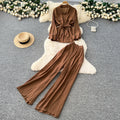 Sophisticated, niche design two-piece set for women: a long-sleeved, tie-waist blouse with a bow detail, paired with high-waisted, wide-leg pants
