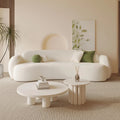Curved, uniquely shaped, cream-toned sofa – a creative and sophisticated addition to clothing stores, beauty salons, office break rooms, and reception areas