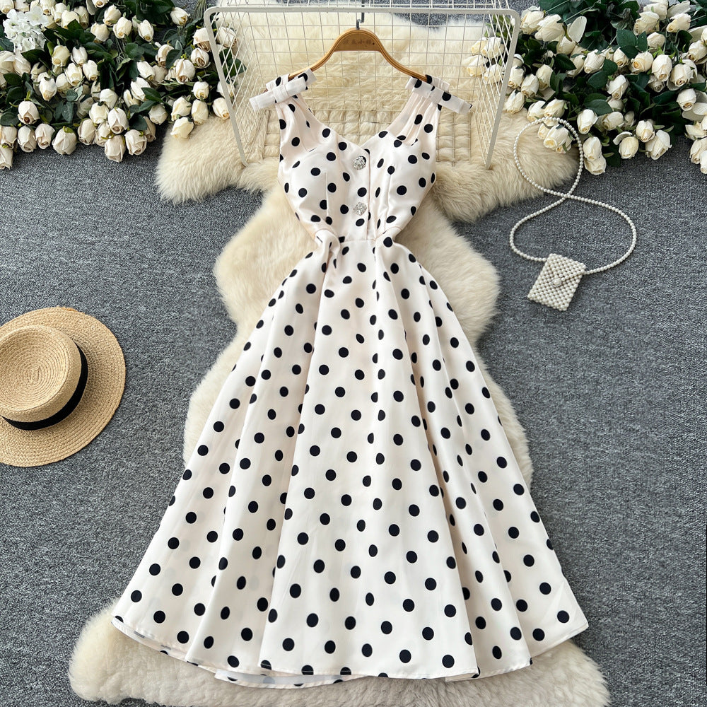 French high-end women's dress - autumn  collection: elegant bow-embellished camisole dress with cinched waist, flared hem, and polka dot detail - a flattering, flowy maxi dress