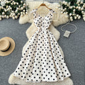 French high-end women's dress - autumn  collection: elegant bow-embellished camisole dress with cinched waist, flared hem, and polka dot detail - a flattering, flowy maxi dress