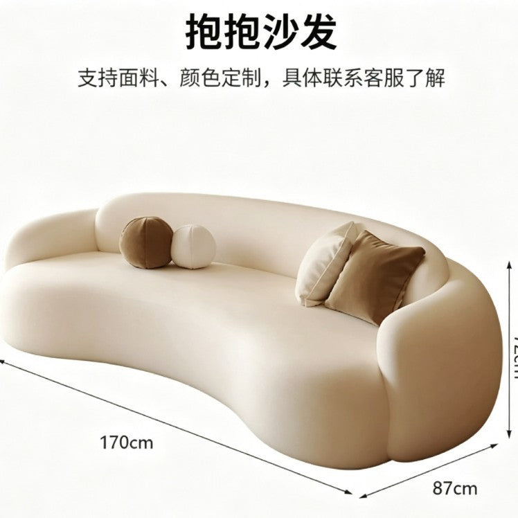 Curved, uniquely shaped, cream-toned sofa – a creative and sophisticated addition to clothing stores, beauty salons, office break rooms, and reception areas