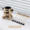 Golden bear berry jar with six gold spoons