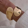 Wholesale glossy open bangle bracelets for the us and european cross-border e-commerce market. unique alloy bangles with an irregular design, perfect for women