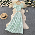 Korean-inspired, stylish and chic women's two-piece set featuring a puff-sleeve, square-neck top and a high-waisted, figure-flattering midi skirt