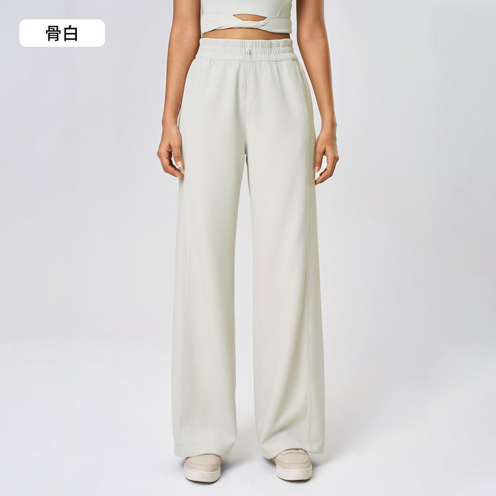 High-waisted, straight-leg pants with a drawstring waistband. versatile and casual, these long pants are designed to elongate the legs with a relaxed, wide-leg fit. perfect for running and workouts. style d25048