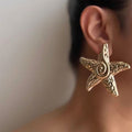 Wholesale seaside earrings: cross-border summer ocean resort style alloy starfish earrings for women - european and american niche exaggerated dangle earrings