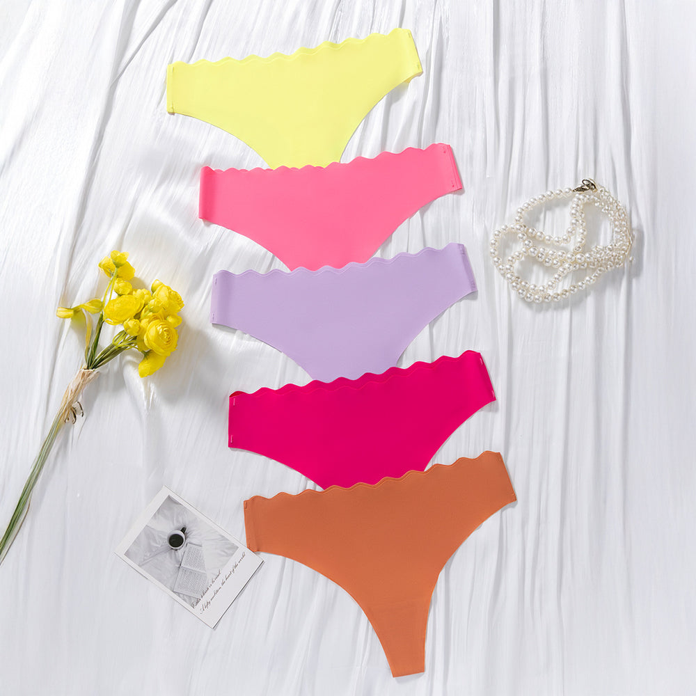 European and american  low-waist seamless ice silk underwear one-piece adhesive pure color cut out wavy waist women's underwear