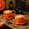 Creative halloween-themed ceramic cup and saucer set, featuring an irregular design with pumpkin and bat motifs. perfect for coffee or tea