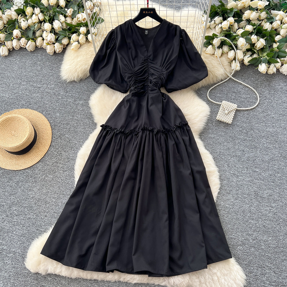 French-inspired, niche v-neck dress with ruched waist, puff sleeves, and a flowy, a-line silhouette. perfect for a slimming and elegant summer look