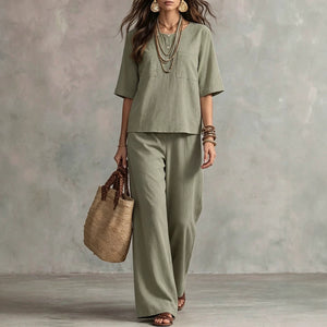 Vintage-inspired, effortlessly chic women's set featuring a solid-color, round-neck, short-sleeved, relaxed-fit top and high-waisted, straight-leg, wide-leg pants. perfect for plus-size women on vacation