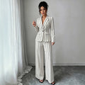 elegant vertical striped commute set: notch lapel blazer with cinched waist, paired with high-waisted, drapey wide-leg trousers for women