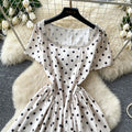 French chic polka dot dress - effortless summer style: square neck, cinched waist, slimming a-line for petite figures