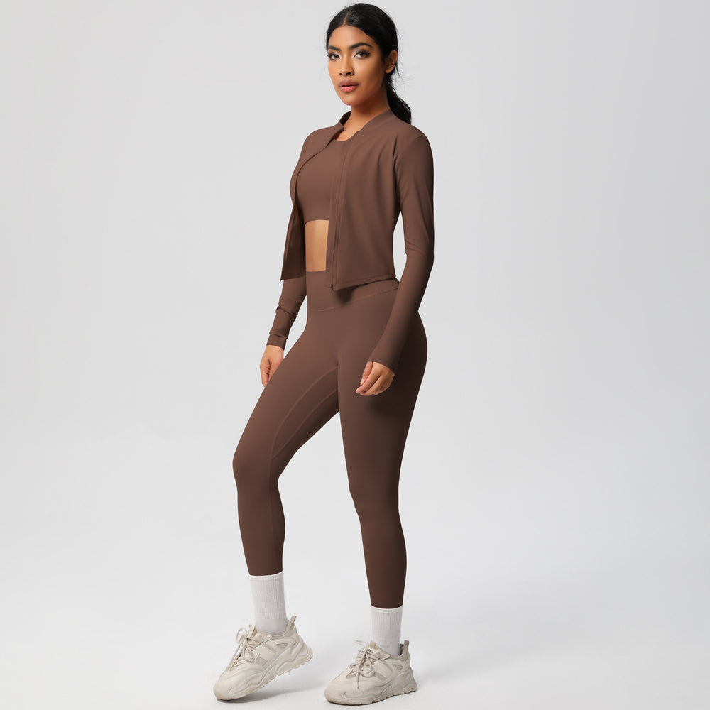 High-waisted, form-fitting yoga pants, a barely-there feel, quick-drying outer layer, and a long-sleeved tee – a women's three-piece activewear set perfect for running and workouts