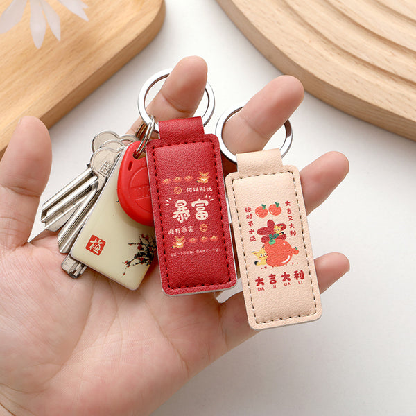 The new PU leather car keychain has a good meaning of anti-lost key ring, embossable logo leather key chain wholesale.