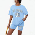 Girls' t-shirt and shorts set featuring a cartoon short-sleeve design and printed graphics, perfect for casual streetwear