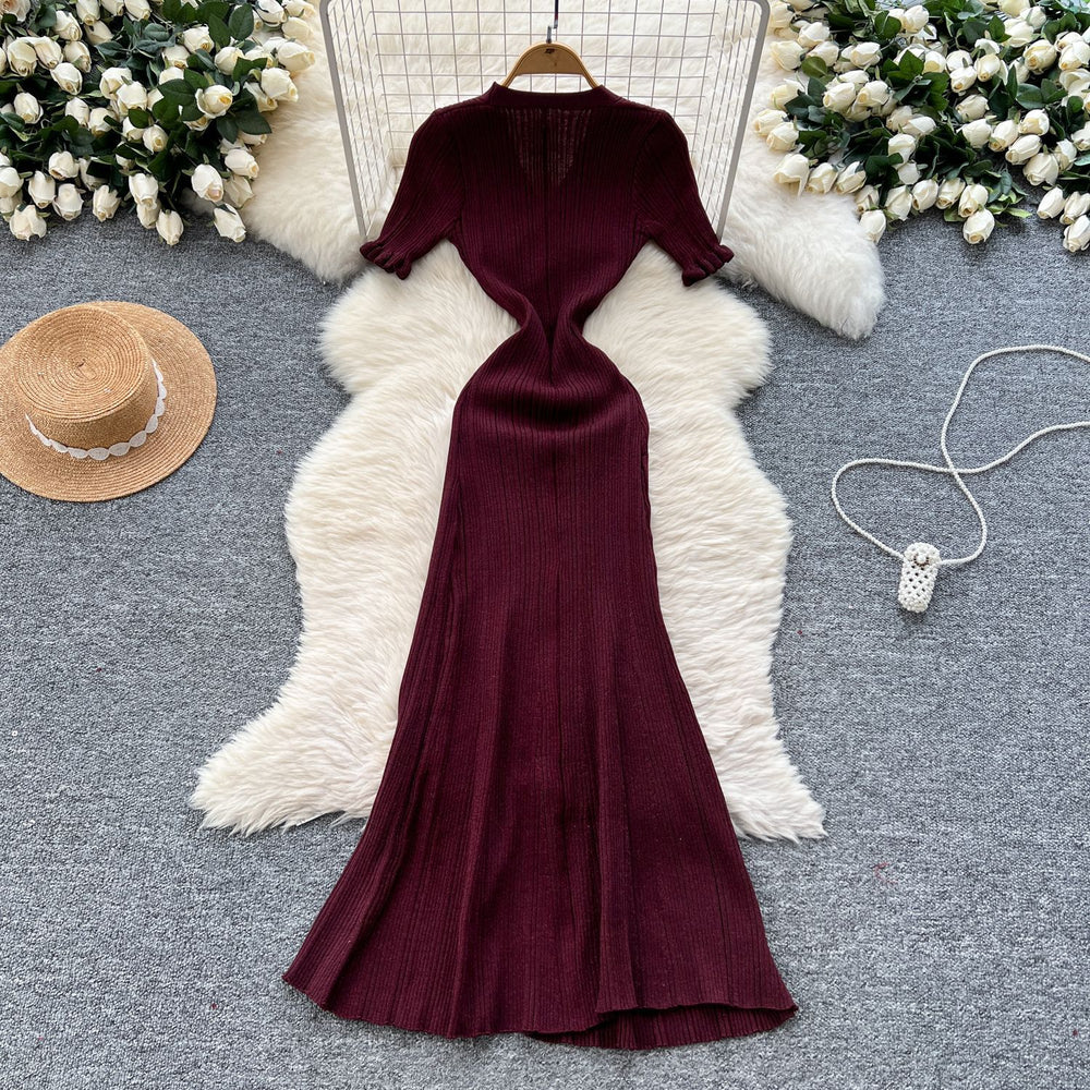 Elegant and sophisticated v-neck short-sleeve knit dress for women, perfect for summer. features a slimming, single-breasted design with a slit and shimmering silk details. a long, chic sweater dress