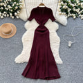 Elegant and sophisticated v-neck short-sleeve knit dress for women, perfect for summer. features a slimming, single-breasted design with a slit and shimmering silk details. a long, chic sweater dress