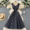 French high-end women's dress - autumn  collection: elegant bow-embellished camisole dress with cinched waist, flared hem, and polka dot detail - a flattering, flowy maxi dress