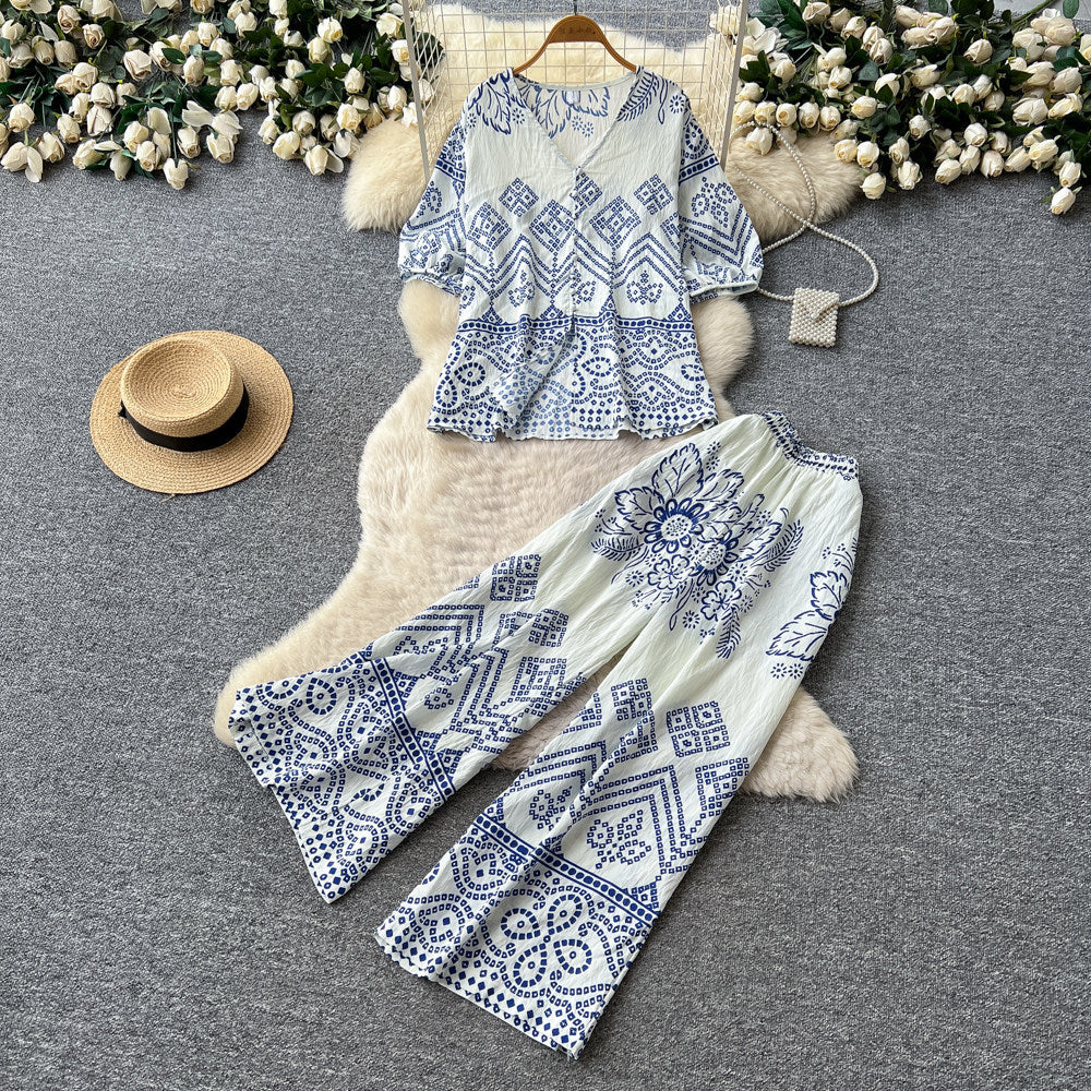 Vacation-ready green floral print two-piece set for women. summer v-neck, slimming wide-leg pants, perfect for both work and play. a stylish and chic outfit