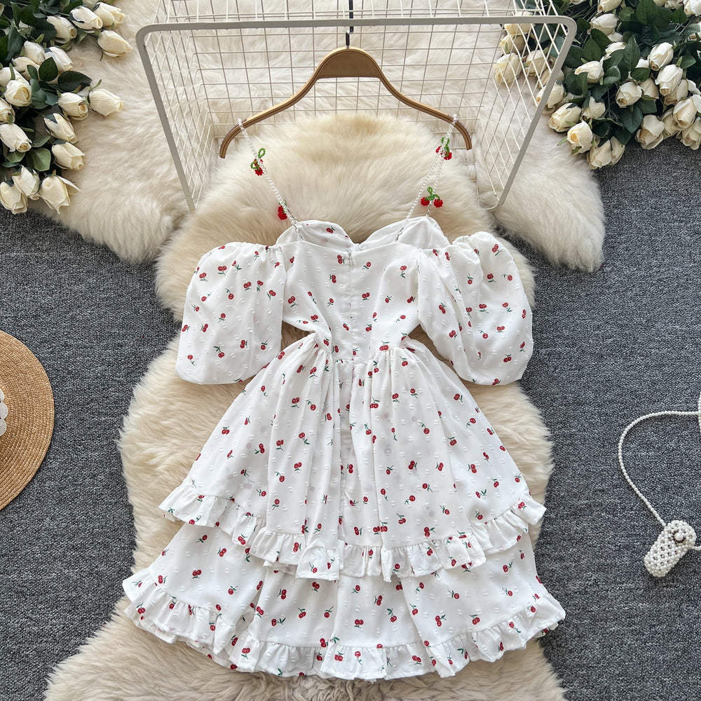 spring/summer sweet one-shoulder cami dress with bubble short sleeves, cherry print, cinched waist, and ruffle hem