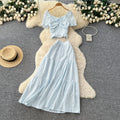 Korean-inspired, stylish and chic women's two-piece set featuring a puff-sleeve, square-neck top and a high-waisted, figure-flattering midi skirt