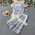 Vacation-ready green floral print two-piece set for women. summer v-neck, slimming wide-leg pants, perfect for both work and play. a stylish and chic outfit