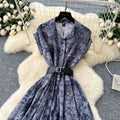 French chic, sophisticated, and unique: tie-waist, short-sleeve, single-breasted, fashionable printed pleated shirt dress with a touch of class