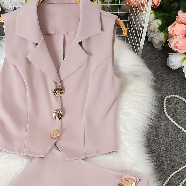 Women's sleeveless vest with suit collar + high-waisted midi skirt set, featuring metal buckle detail