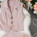Women's sleeveless vest with suit collar + high-waisted midi skirt set, featuring metal buckle detail