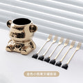 Golden bear berry jar with six gold forks