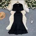 Elegant and alluring, this high-end, figure-hugging, mid-length mermaid gown features a plunging neckline, short sleeves, hot-fix rhinestone embellishments, and a daring slit. perfect for the sophisticated woman