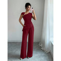 Women's elegant sleeveless fitted top with metal accents and asymmetrical hem, paired with loose straight-leg pants - 2-piece set