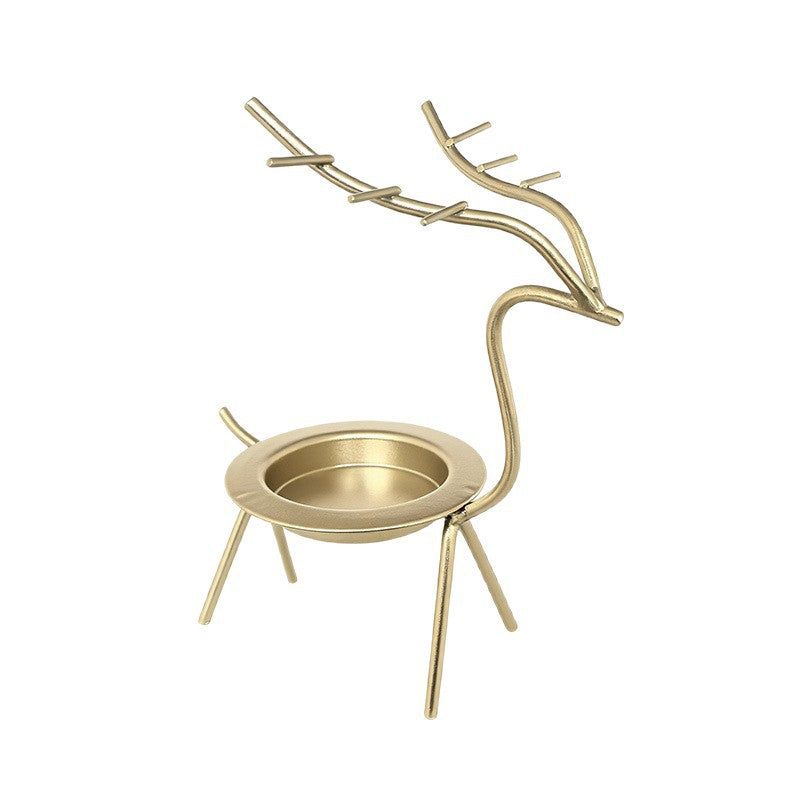 French-chic holiday decorations: deer and elk shaped iron candle holders, golden decorative pieces for restaurant tabletops