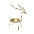 French-chic holiday decorations: deer and elk shaped iron candle holders, golden decorative pieces for restaurant tabletops