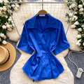 Korean-inspired, design-forward, cinched-waist blouse for women. spring collection, short-sleeved, relaxed-fit, open-front cardigan. elegant and sophisticated, with a touch of french flair