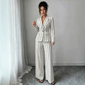 elegant vertical striped commute set: notch lapel blazer with cinched waist, paired with high-waisted, drapey wide-leg trousers for women