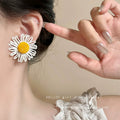Milky soft, woven raffia daisy flower earrings for women. statement beach earrings designed to flatter the face with a touch of high-end elegance
