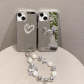 Mirror-finish apple 16 pro silver bowknot phone case, iphone 15/12 compatible, anti-drop hard protective case with wrist strap