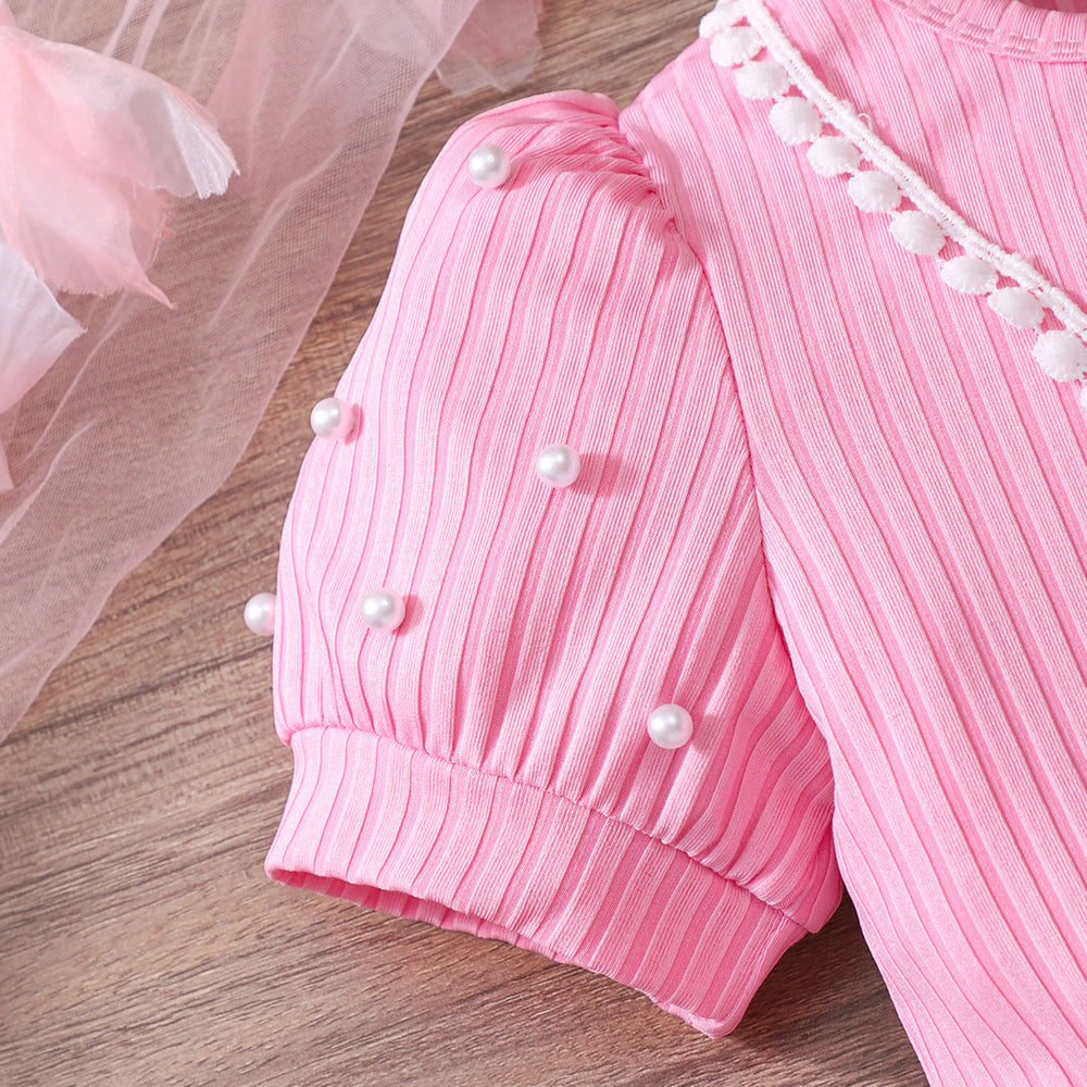 Girls' ribbed knit dress with heart-shaped mesh sleeves and pearl accents, includes crossbody bag