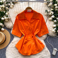Korean-inspired, design-forward, cinched-waist blouse for women. spring collection, short-sleeved, relaxed-fit, open-front cardigan. elegant and sophisticated, with a touch of french flair