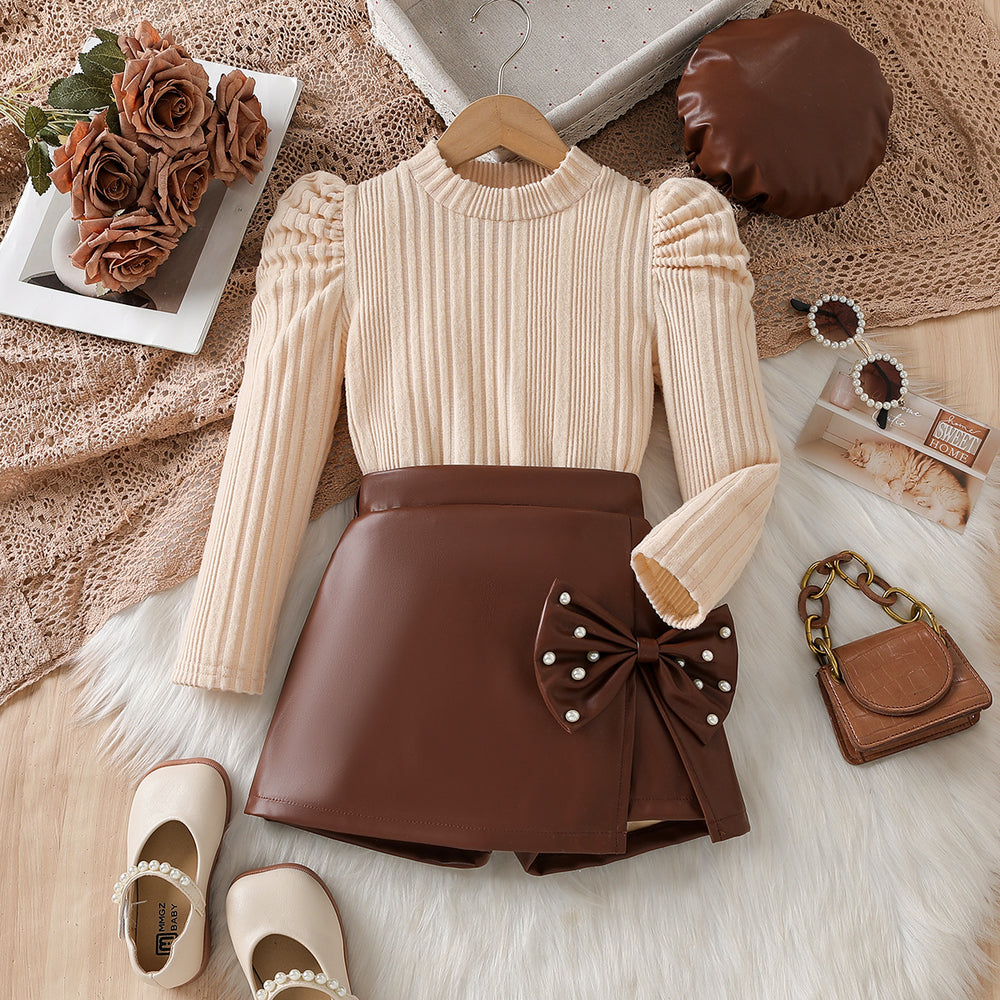 autumn new arrival: round neck princess sleeve textured top + asymmetrical bow leather skirt two-piece set