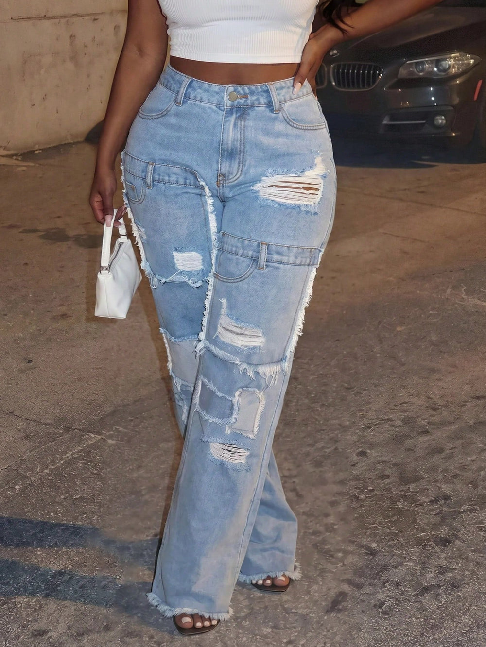 Women's light blue distressed wide-leg jeans with ripped hems, high waist, and frayed details - new autumn collection