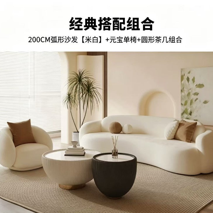 Curved, uniquely shaped, cream-toned sofa – a creative and sophisticated addition to clothing stores, beauty salons, office break rooms, and reception areas