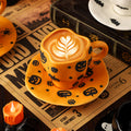 Creative halloween-themed ceramic cup and saucer set, featuring an irregular design with pumpkin and bat motifs. perfect for coffee or tea