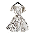 French chic polka dot dress - effortless summer style: square neck, cinched waist, slimming a-line for petite figures