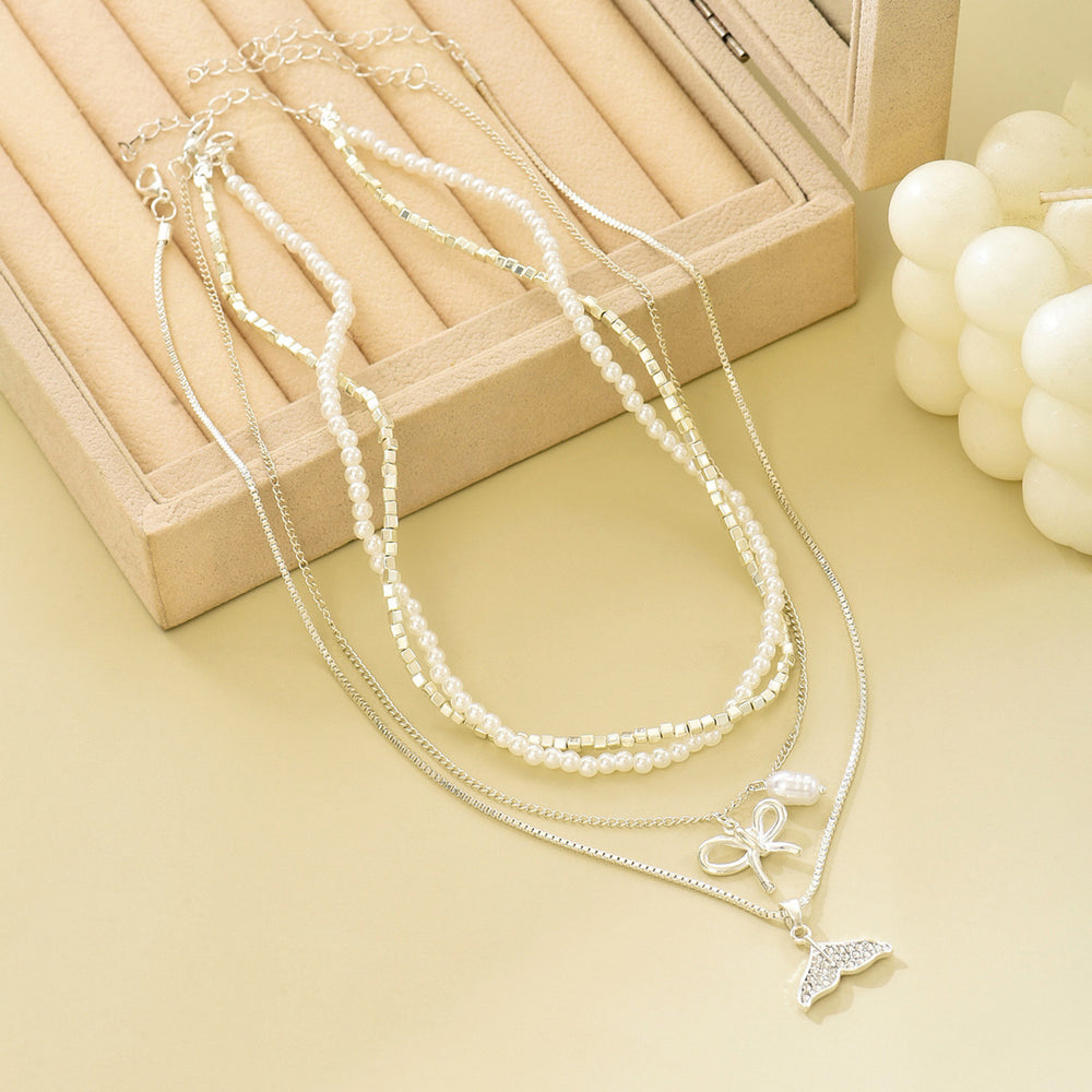 Wholesale diamond-studded mermaid tail bow pendant necklace - european & american cross-border, light luxury, high-end style - women's layering necklace with faux pearl accents